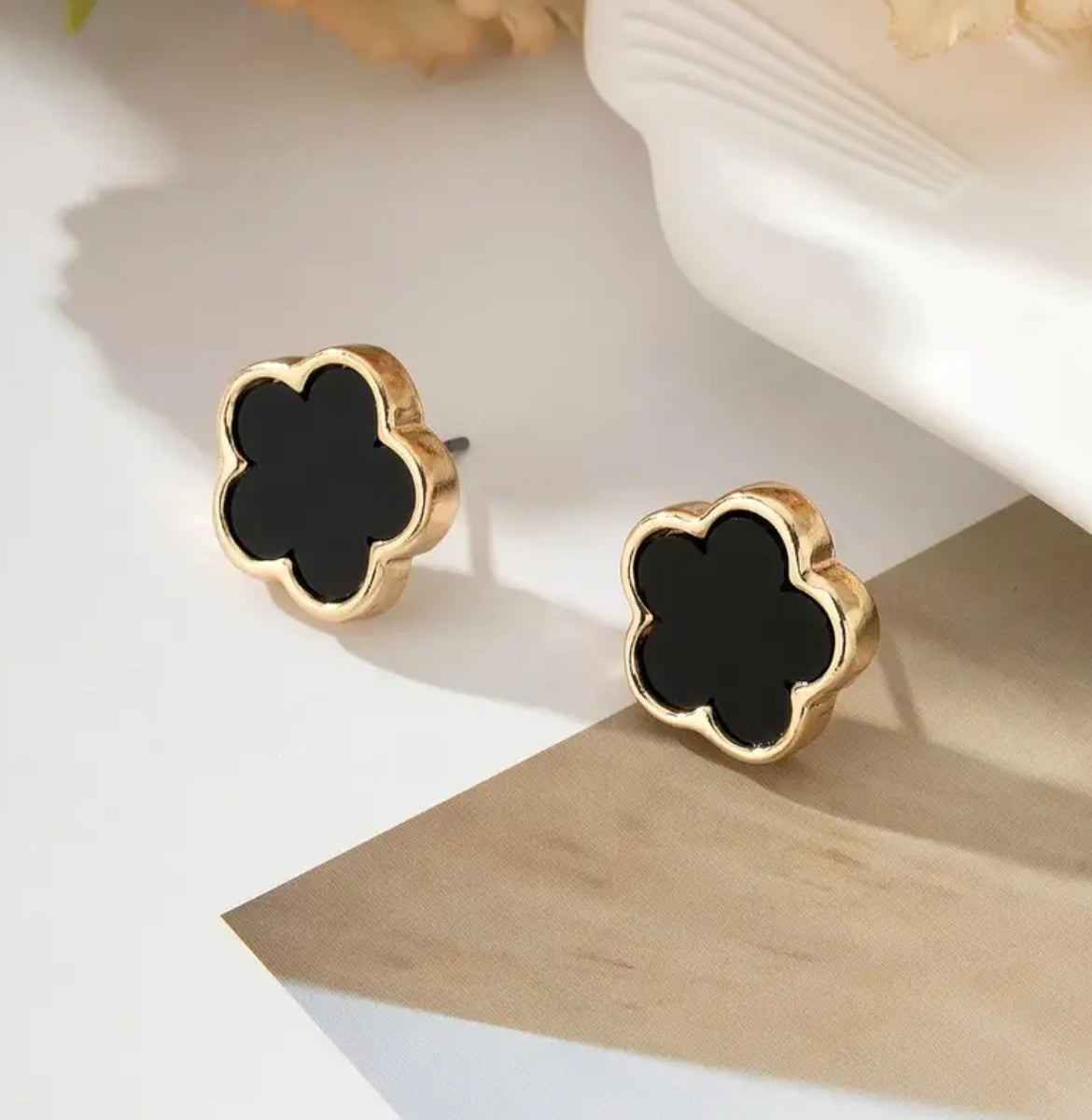 Black four leaf studs